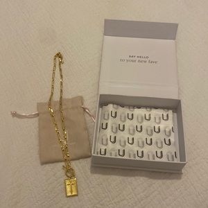 Uncommon James gold paper clip cross necklace